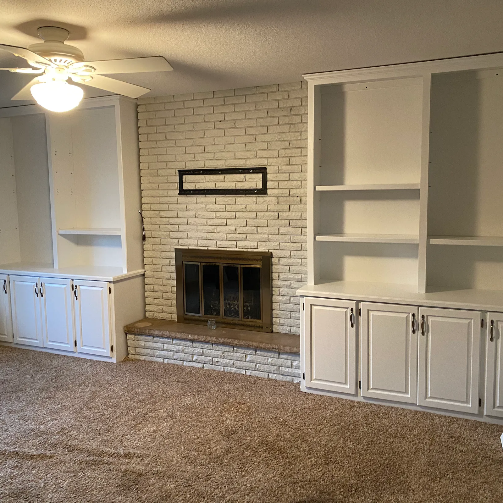 Interior room with built-ins and a fireplace painted by Villa's Pro Painting